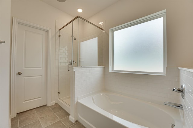 bathroom with tile patterned flooring and separate shower and tub