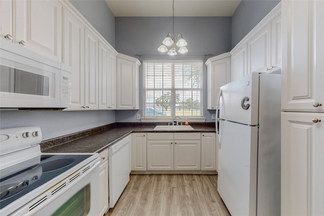 kitchen featuring white cabinetry, white appliances, sink, and pendant lighting