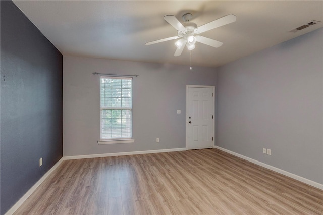 spare room featuring light hardwood / wood-style flooring and ceiling fan