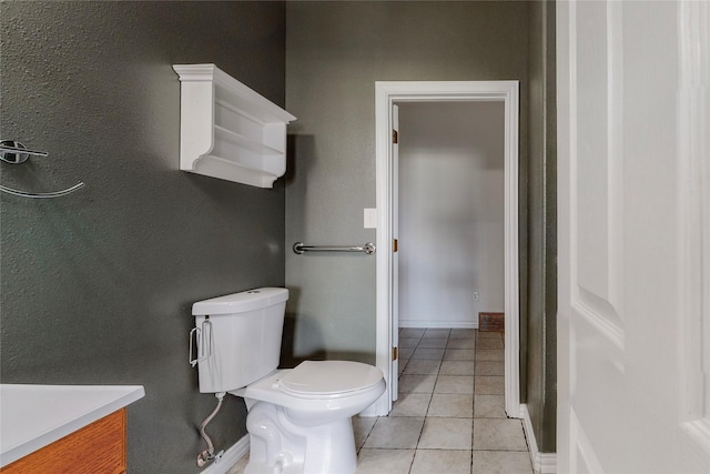 bathroom with tile patterned flooring, vanity, and toilet