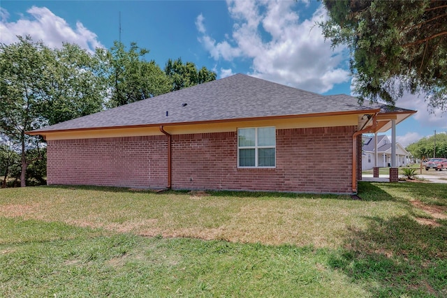 view of side of property with a lawn