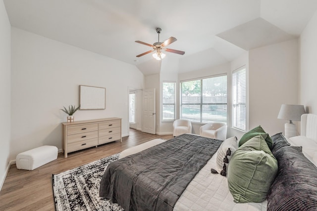 bedroom featuring ceiling fan, wood-type flooring, and lofted ceiling