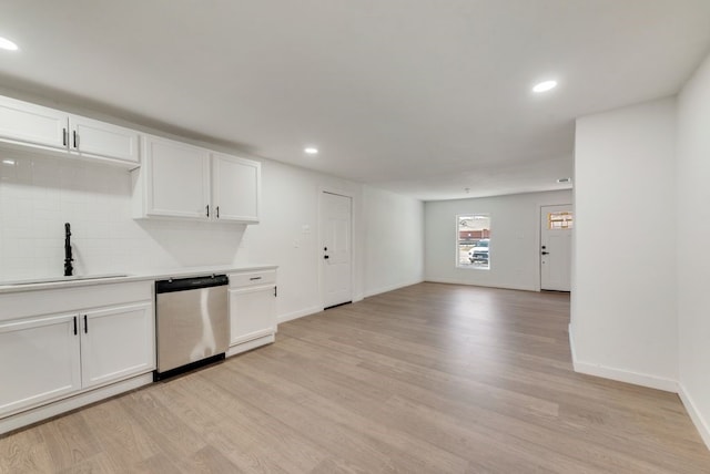 kitchen featuring sink, dishwasher, white cabinetry, tasteful backsplash, and light wood-type flooring