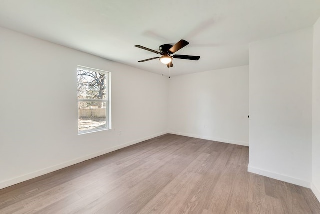 spare room featuring light hardwood / wood-style flooring and ceiling fan