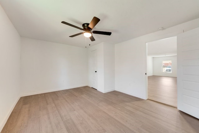 empty room featuring ceiling fan and light hardwood / wood-style floors