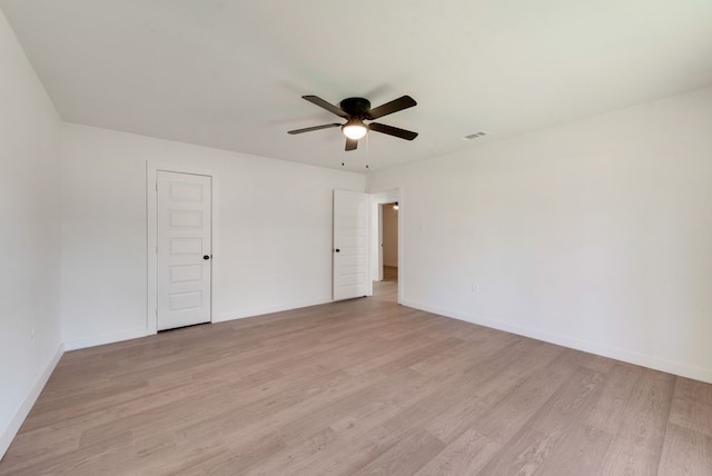 empty room featuring ceiling fan and light hardwood / wood-style floors