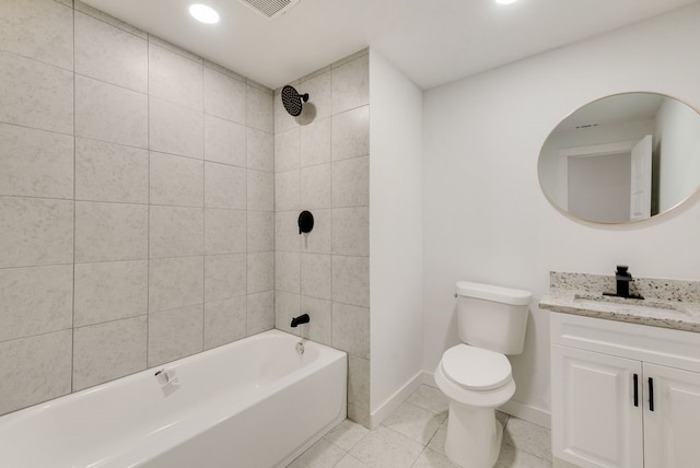 full bathroom featuring vanity, tile patterned flooring, tiled shower / bath combo, and toilet