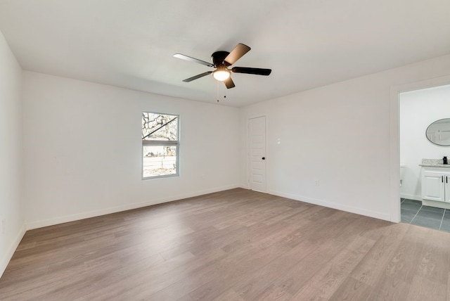 spare room with ceiling fan and light hardwood / wood-style flooring