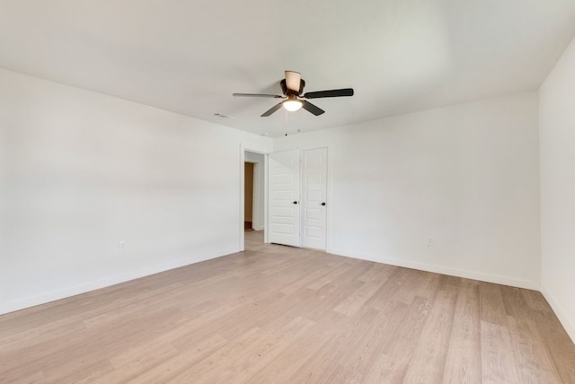 spare room with light hardwood / wood-style flooring and ceiling fan