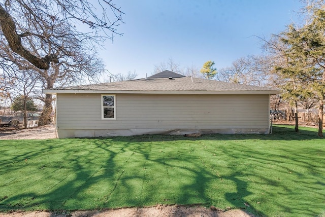 back of house with a lawn