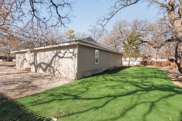 view of property exterior with a lawn