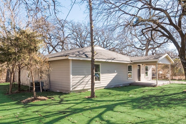 rear view of house featuring a patio and a lawn