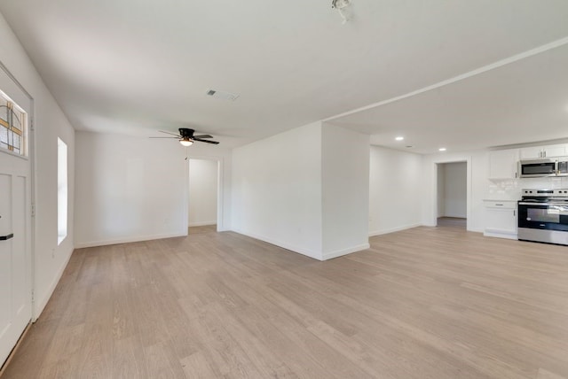 unfurnished living room featuring ceiling fan and light wood-type flooring