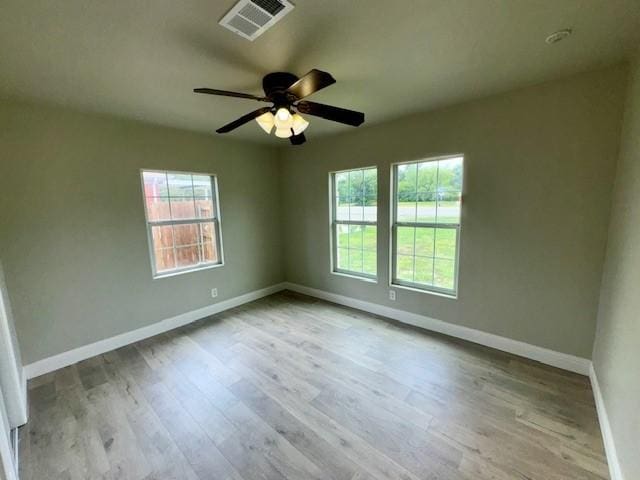 spare room featuring light hardwood / wood-style flooring and ceiling fan