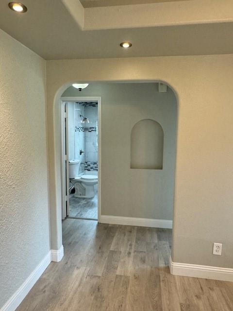 hallway with hardwood / wood-style flooring