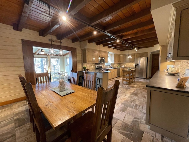 dining space featuring track lighting, wooden ceiling, and beam ceiling