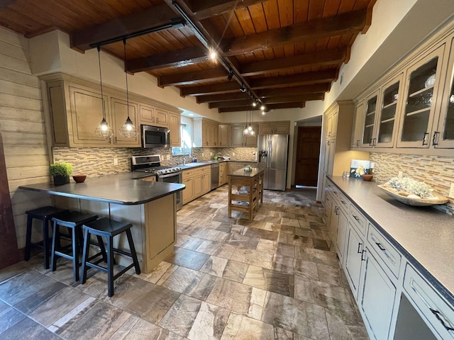 kitchen featuring hanging light fixtures, stainless steel appliances, a kitchen bar, wooden ceiling, and beamed ceiling