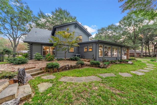 rear view of property with a lawn