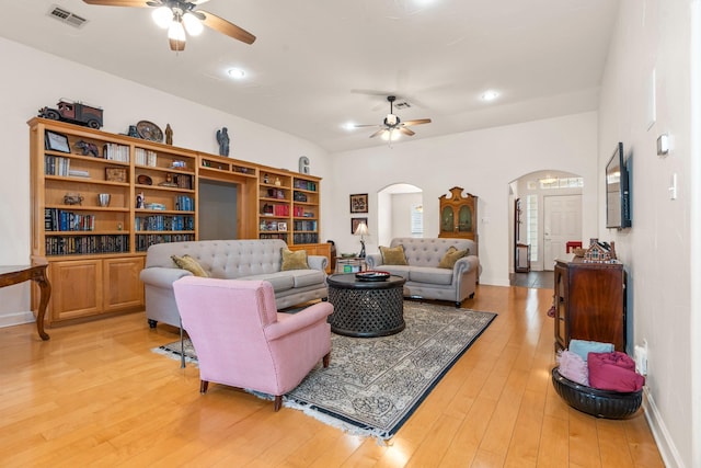 living room with hardwood / wood-style floors and ceiling fan