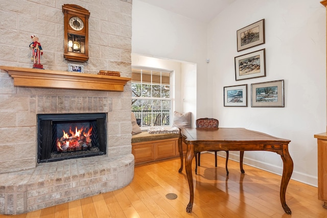 office space with a fireplace and light hardwood / wood-style flooring