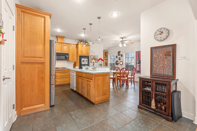 kitchen with pendant lighting, sink, ceiling fan, a kitchen island with sink, and black appliances