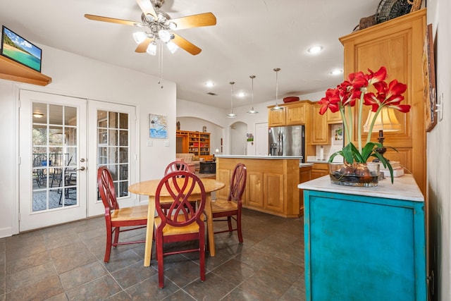 dining space with ceiling fan and french doors