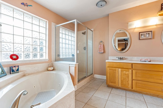 bathroom with tile patterned flooring, shower with separate bathtub, and vanity