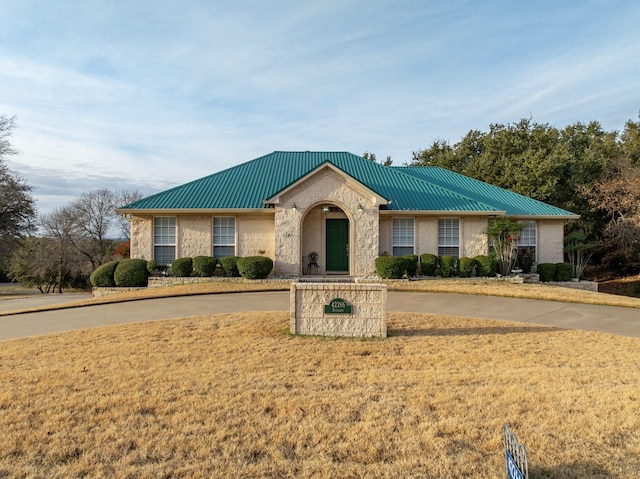 ranch-style house with a front lawn