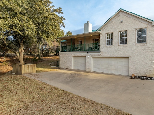 view of front of home with a balcony and a garage