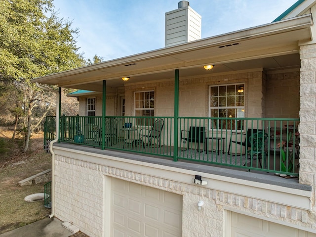 exterior space featuring a garage and covered porch