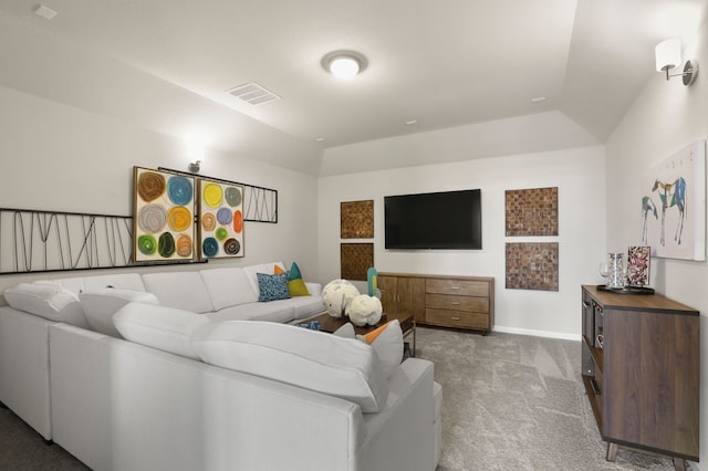 living room featuring lofted ceiling, carpet flooring, and a tray ceiling