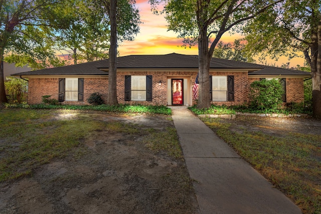 ranch-style house with a yard