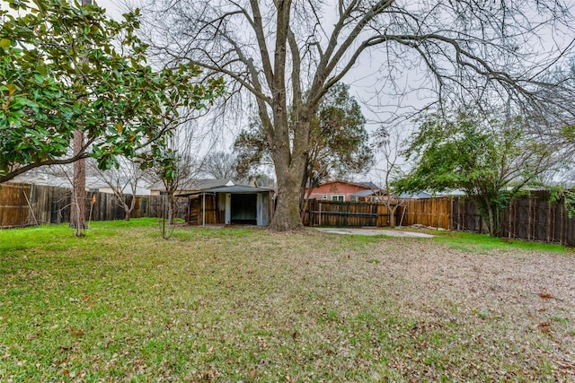 view of yard with an outbuilding and a fenced backyard