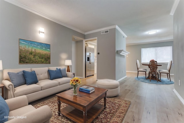 living room featuring light hardwood / wood-style flooring and ornamental molding