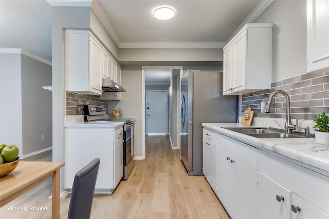 kitchen with under cabinet range hood, ornamental molding, stainless steel appliances, and a sink