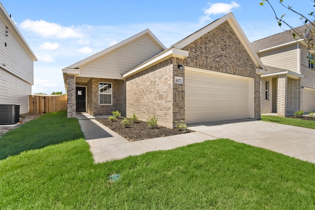 view of front of property featuring a garage, a front lawn, and central air condition unit