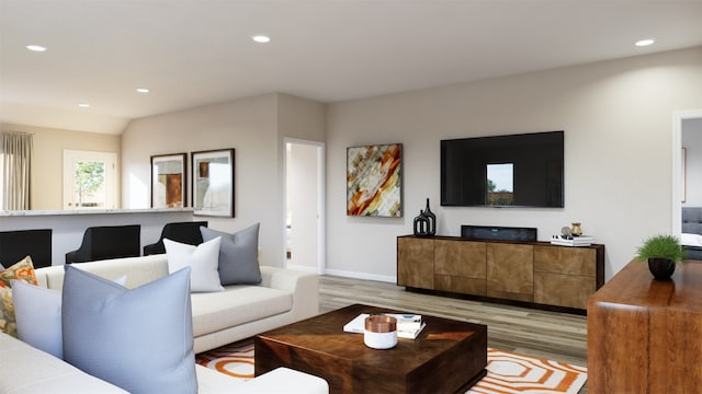 living room featuring light wood-type flooring, baseboards, and recessed lighting