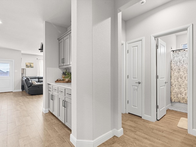 corridor with light hardwood / wood-style flooring