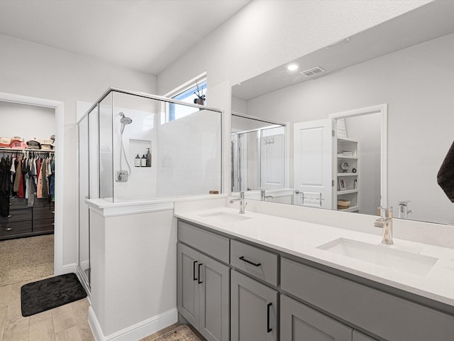 bathroom featuring vanity, hardwood / wood-style floors, and walk in shower