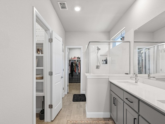 bathroom featuring an enclosed shower, hardwood / wood-style floors, and vanity