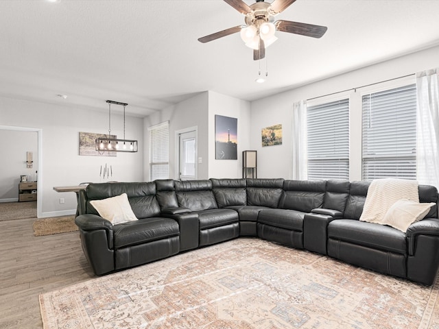 living room with ceiling fan and wood-type flooring