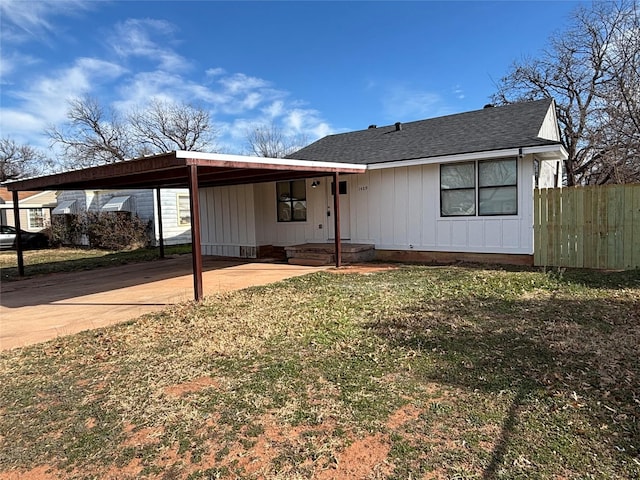 view of front of property with a front lawn and a carport