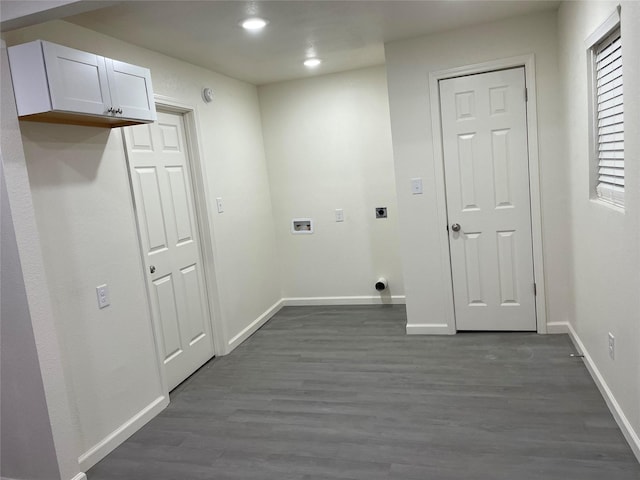 clothes washing area featuring cabinets, electric dryer hookup, washer hookup, and dark hardwood / wood-style flooring