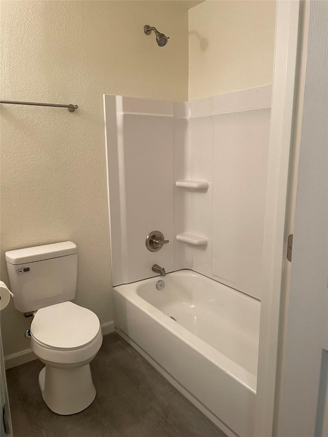 bathroom with bathtub / shower combination and toilet