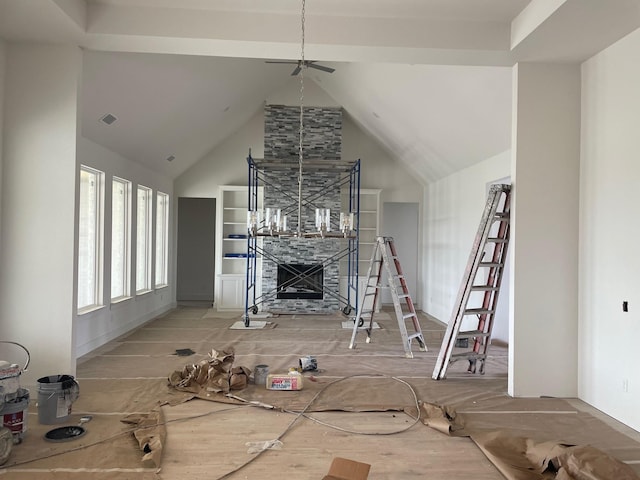 unfurnished living room with visible vents, high vaulted ceiling, and a tile fireplace