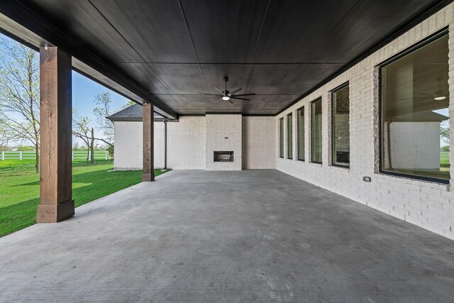 view of patio featuring fence, a carport, and a ceiling fan