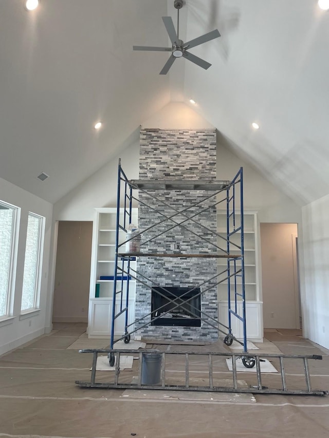 unfurnished living room with visible vents, a large fireplace, high vaulted ceiling, and a ceiling fan