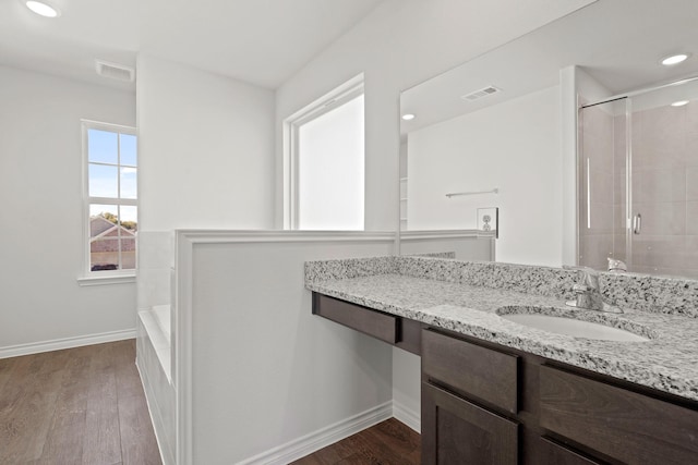 bathroom featuring wood-type flooring, an enclosed shower, and vanity