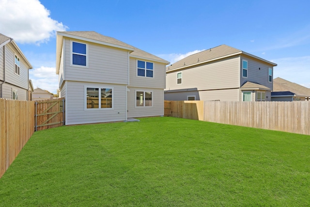 rear view of property with a yard