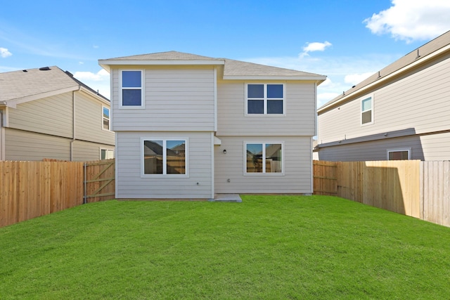 rear view of property with a lawn